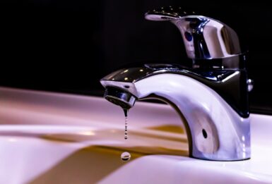 stainless steel faucet on white ceramic sink