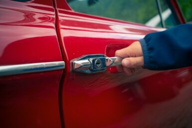 person holding car door