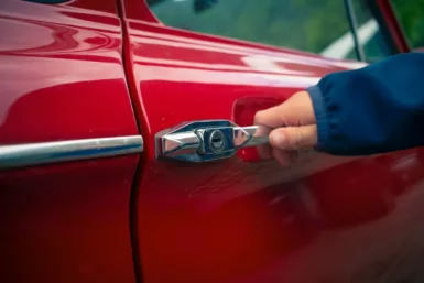 person holding car door