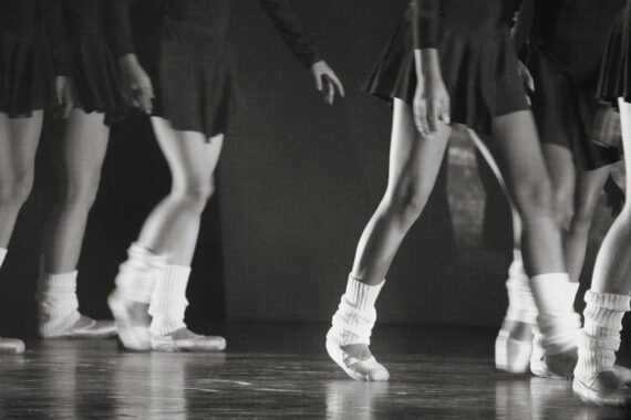 A group of young women standing on top of a dance floor