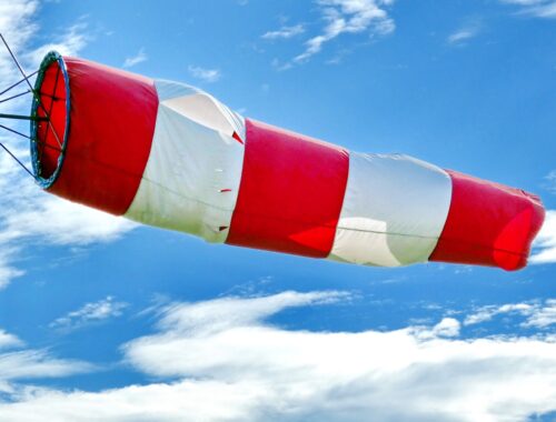red and white flag under blue sky during daytime